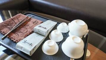 A tray with a chocolate bar, white cups, and a napkin on a table.