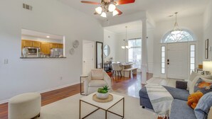 A spacious living room with a ceiling fan, a dining area, and a kitchen visible through an open door. - Savannah Haven w/ Gazebo, Grill & Fire Pit (Savannah)