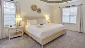 A neatly arranged bedroom with a bed, bedside tables, and a ceiling fan. - Savannah Haven w/ Gazebo, Grill & Fire Pit (Savannah)