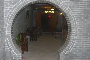 A brick-walled corridor with a wooden door at the end. - Huangyao Ancient Town (Zhaoping)