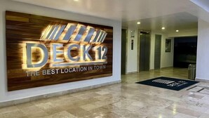 L’entrée d’un hôtel, avec une grande enseigne indiquant : « DECK12, le meilleur emplacement en ville ».