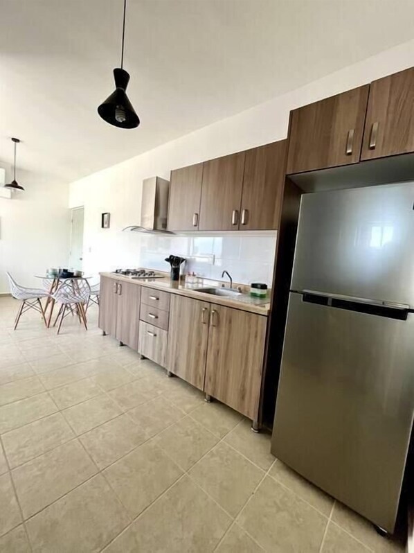 Fridge, microwave, stovetop, coffee/tea maker