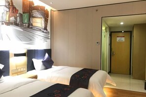 A hotel room with two beds, a nightstand, a wall-mounted lamp, and a door leading to another room. - Yi mi select hotel (Guangzhou Science City Jiada store ) (Guangzhou)