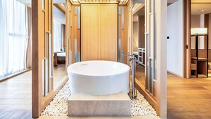 A modern bathroom with a freestanding bathtub, wooden paneling, and a view to the adjacent room. - Swissotel Hot Spring Hotel Xi'an Xinxing (Xi'an)