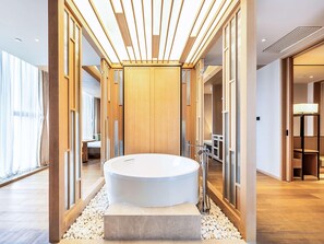A modern bathroom with a freestanding bathtub, wooden paneling, and a view of the adjacent room. - Swissotel Hot Spring Hotel Xi'an Xinxing (Xi'an)