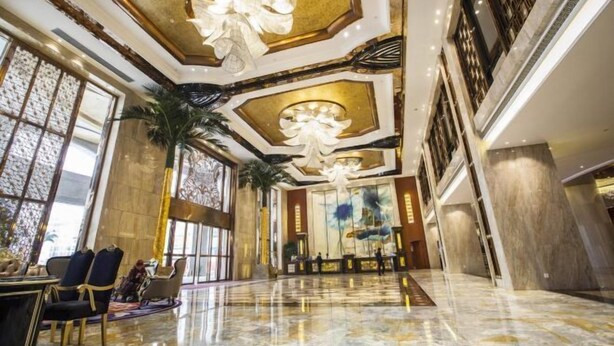 A spacious lobby with a high ceiling, large windows, and a marble floor. - Jiahua Hotel (Puning)