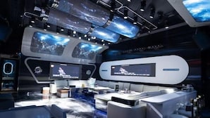 A modern, high-tech control room with multiple screens, a central console, and a bar area. - Jiahua Hotel (Puning)