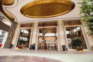 A grand lobby with a large entrance, columns, and a decorative ceiling. - Jiahua Hotel (Puning)