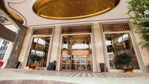 A grand entrance with a large, circular ceiling and a central glass door. - Jiahua Hotel (Puning)