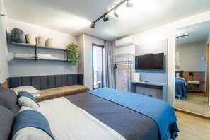 A modern hotel room with a large bed, a desk, a TV, and a mirror. - Life resort (Brasília)
