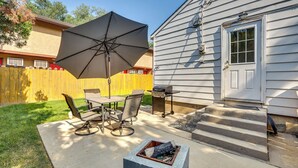 A patio with a table and chairs, a large umbrella, and a fire pit. - Pet-Friendly Meridian Getaway Near Downtown (Meridian)