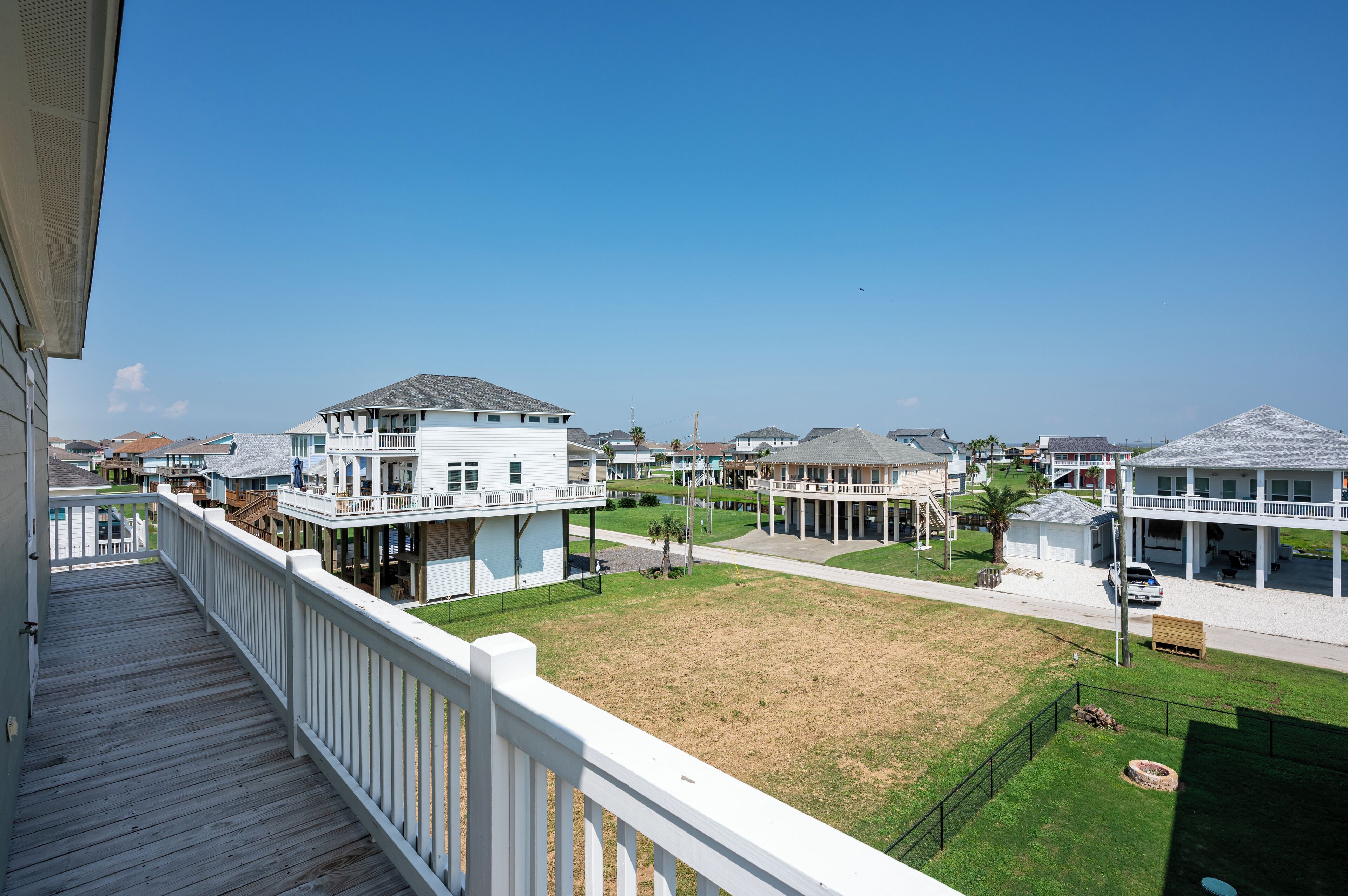 A coastal residential area with houses featuring balconies and waterfront views.