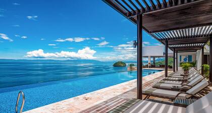 Luxurious 6th-floor condo with pool, oceanfront balcony & water view