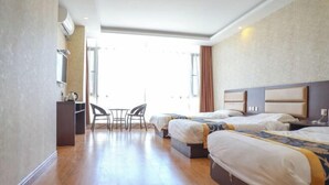 A hotel room with two beds, a desk, a chair, and a large window. - Yida Hotel (Changbai Mountain West Slope Tourist Transfer Center) (Fusong)