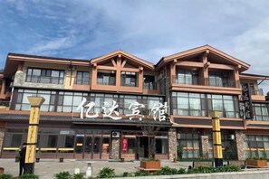 A multi-story hotel with a traditional architectural style, featuring large windows and a prominent entrance.