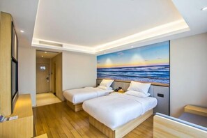 A hotel room with two beds, a painting of a sunset over the ocean, wooden flooring, and a small desk. - Starway Hotel (Hangzhou Binjiang Jiangnan Avenue) (Hangzhou)