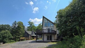 A modern two-story building with a balcony and a staircase leading to the upper floor. - Family Mountain Escape w/ Hot Tub & Game Room (Oakland)