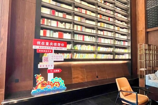 A library with bookshelves and a chair.