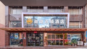A hotel with a modern facade, large glass windows, and a prominent logo. - Kaili Shangjie Hotel (International Trade Shopping Center) (Kaili)