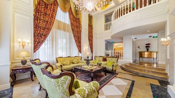 A grand lobby with ornate furniture, a chandelier, and a checkered floor. - Chengdu Star Flower Garden Hotel (University Games Sports Center) (Chengdu)