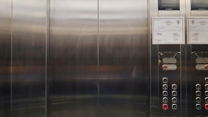 A modern elevator with stainless steel doors, a digital display, and a no-smoking sign. - Reddoorz Plus @ Kaizen Suites Taft Avenue (Manila)
