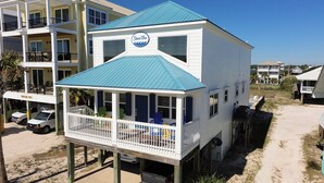 A two-story building with a blue roof and a sign reading "Shore Vue". - Beautiful Home in Gulf Shores with Private Pool, Sleeps 12 (Gulf Shores)