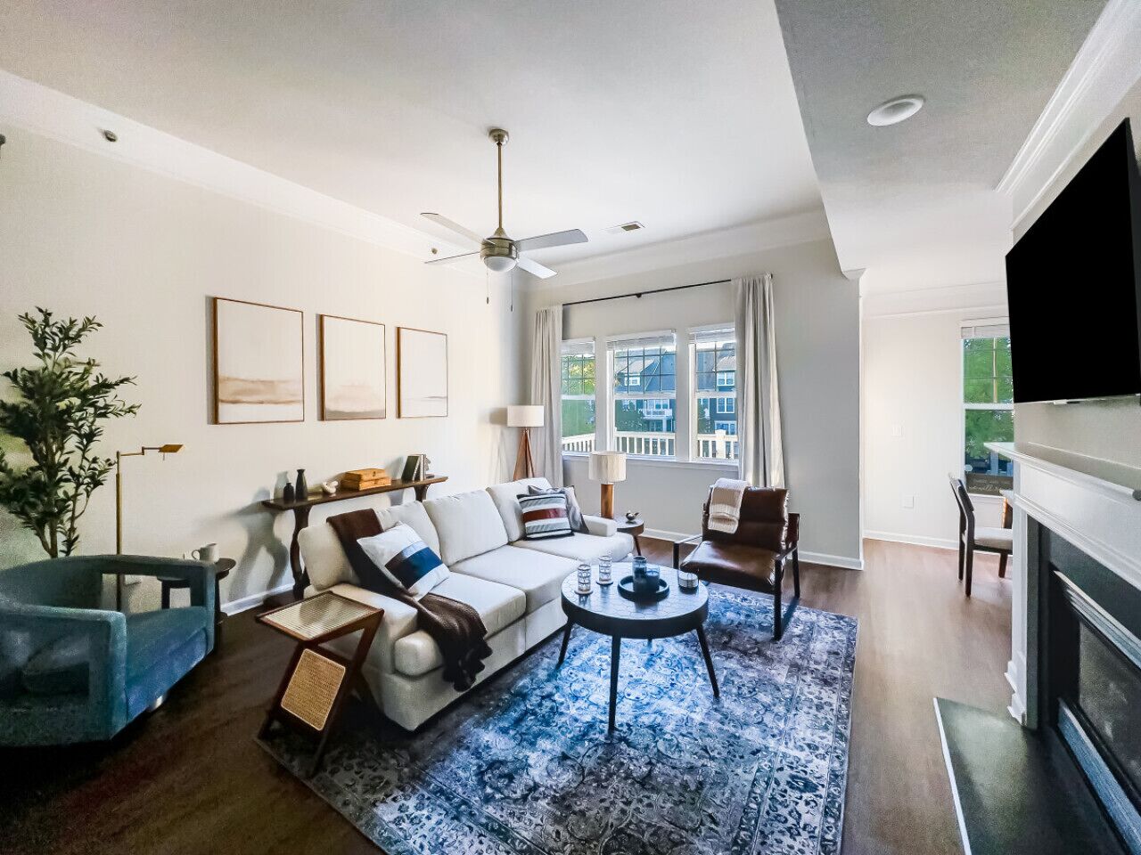 A living room with a sofa, armchair, coffee table, and a fireplace.