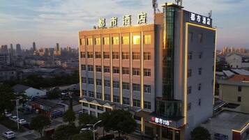 A multi-story hotel with a modern facade and illuminated signage.