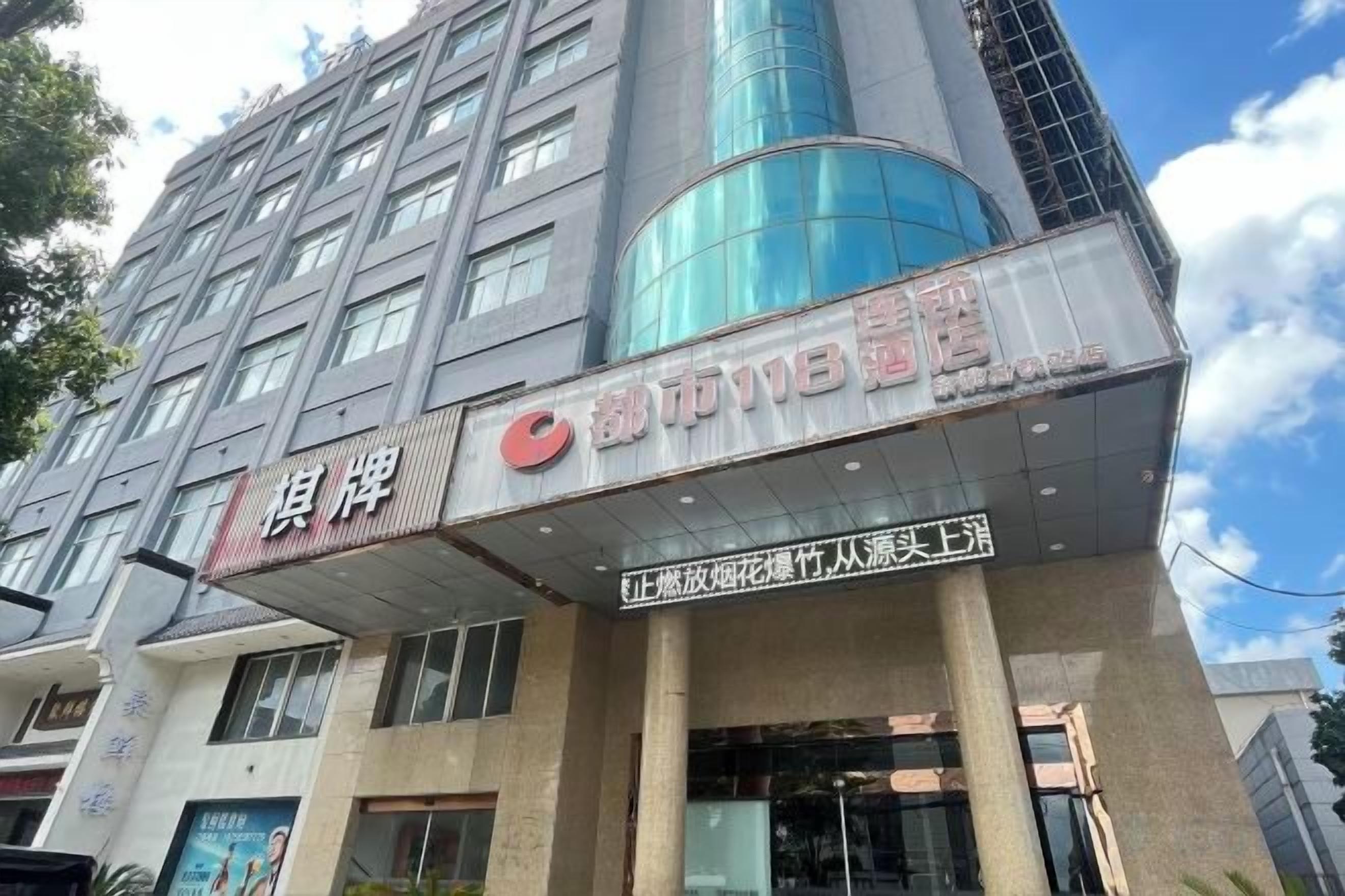 A hotel with a prominent sign, multiple floors, and a modern architectural design.