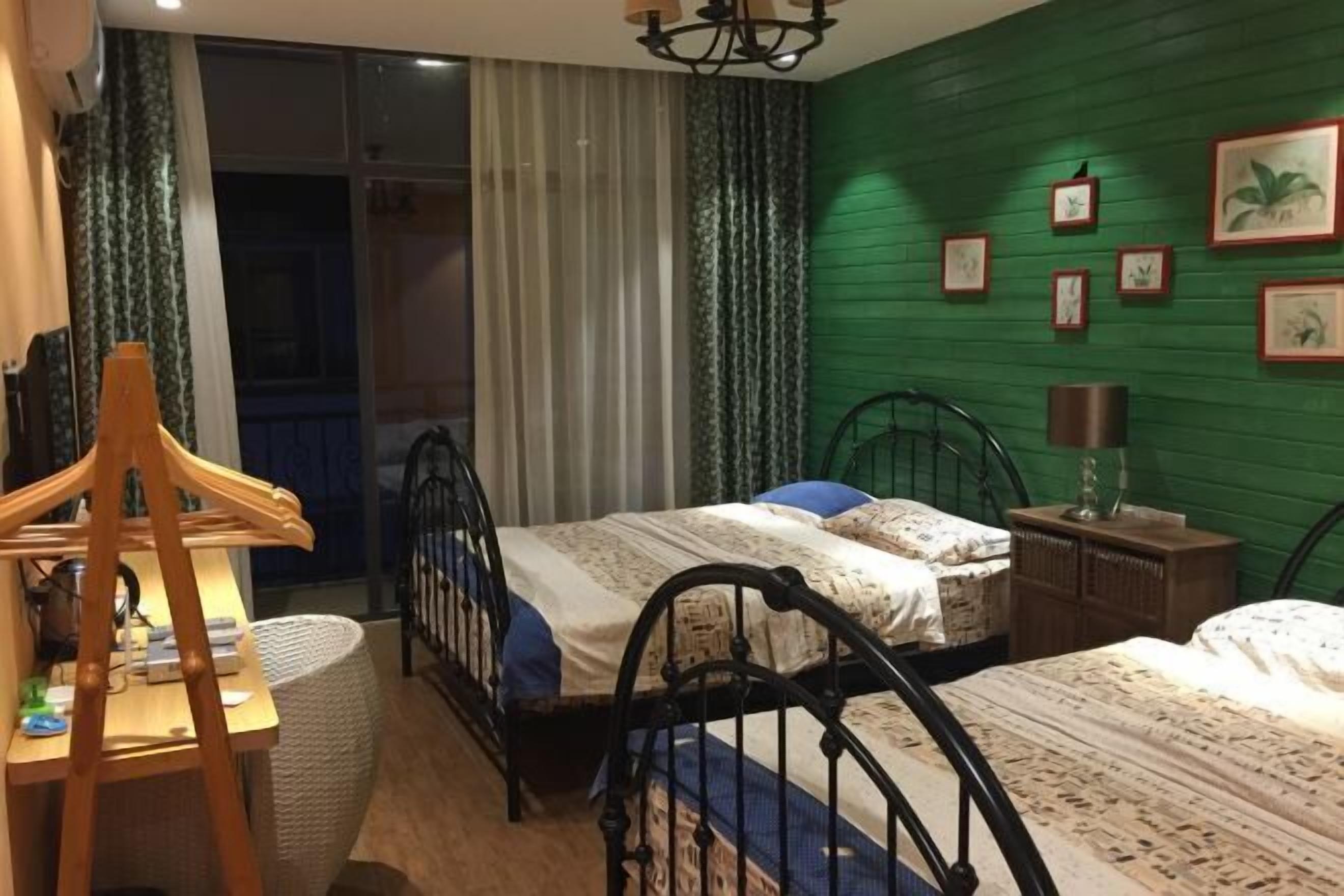 A room with two beds, a desk, and a chair.