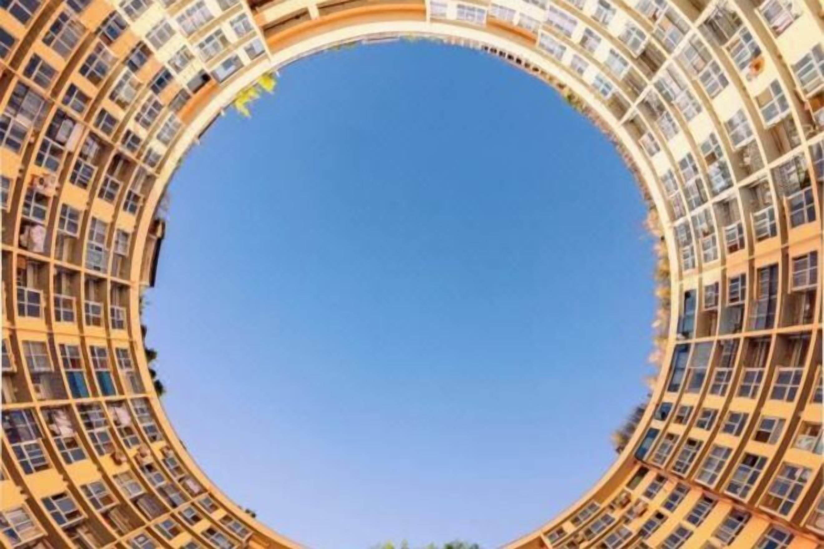 A circular building with multiple floors and balconies.