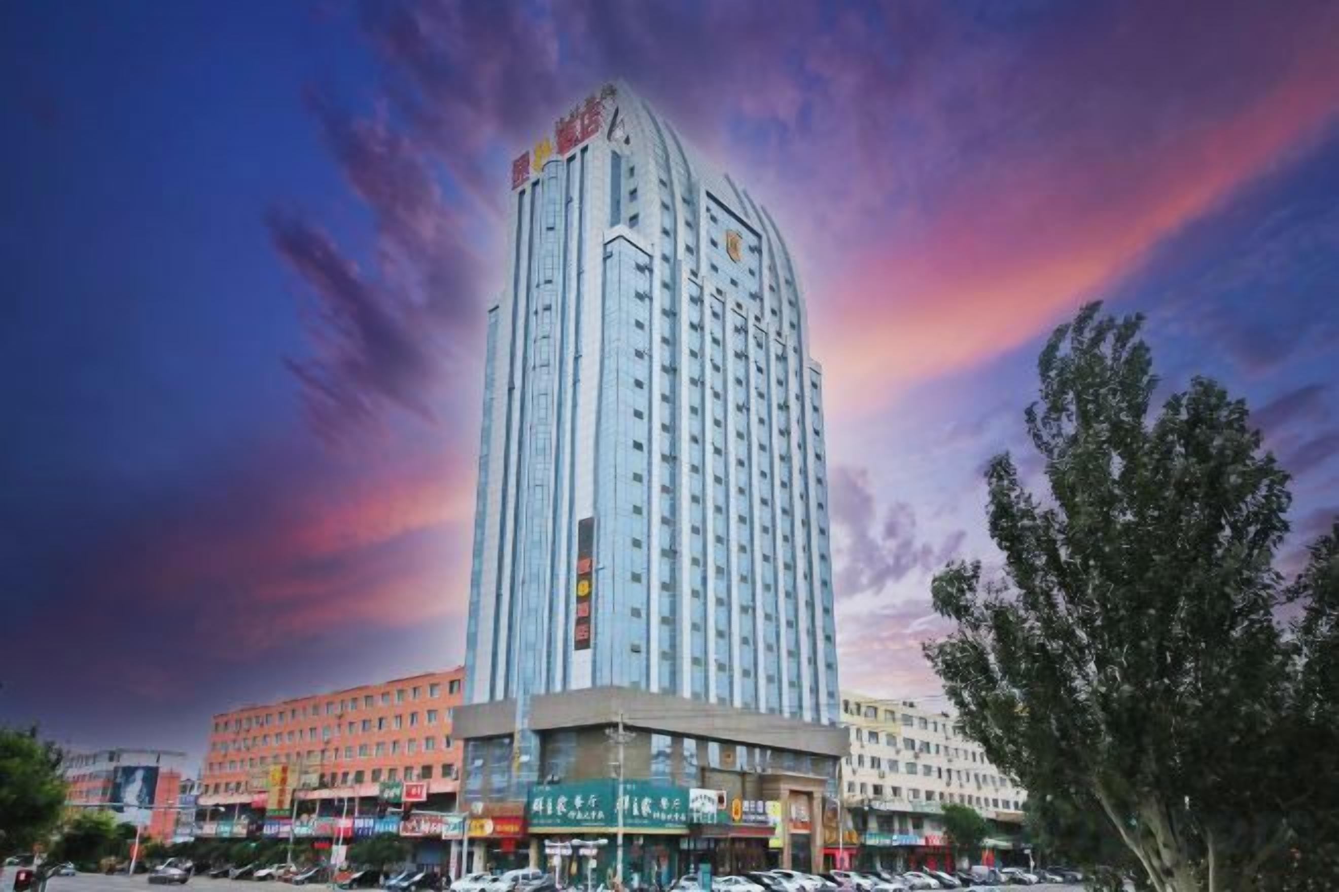 A tall hotel with multiple floors and a central entrance.
