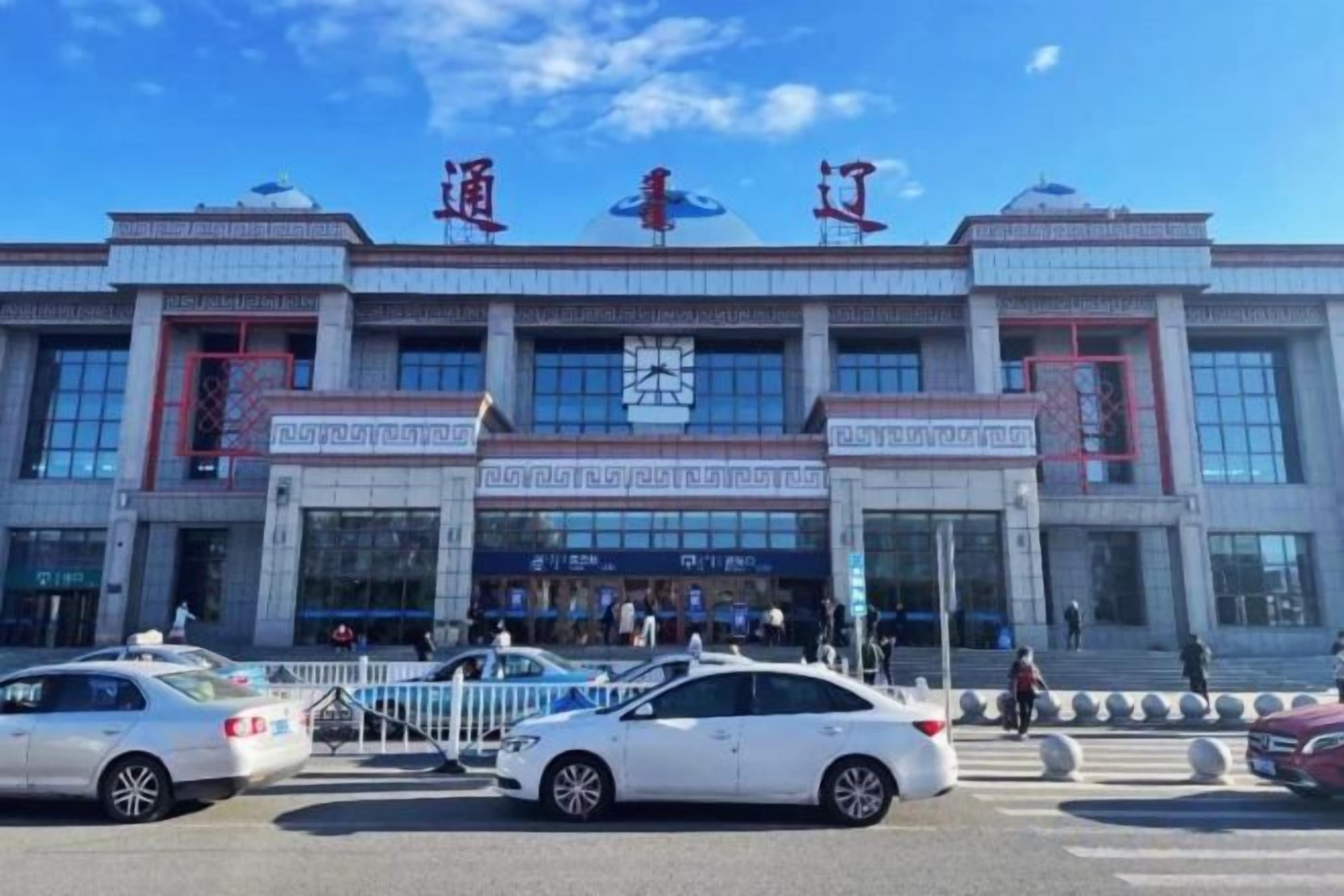 A large building with a prominent entrance and multiple windows.