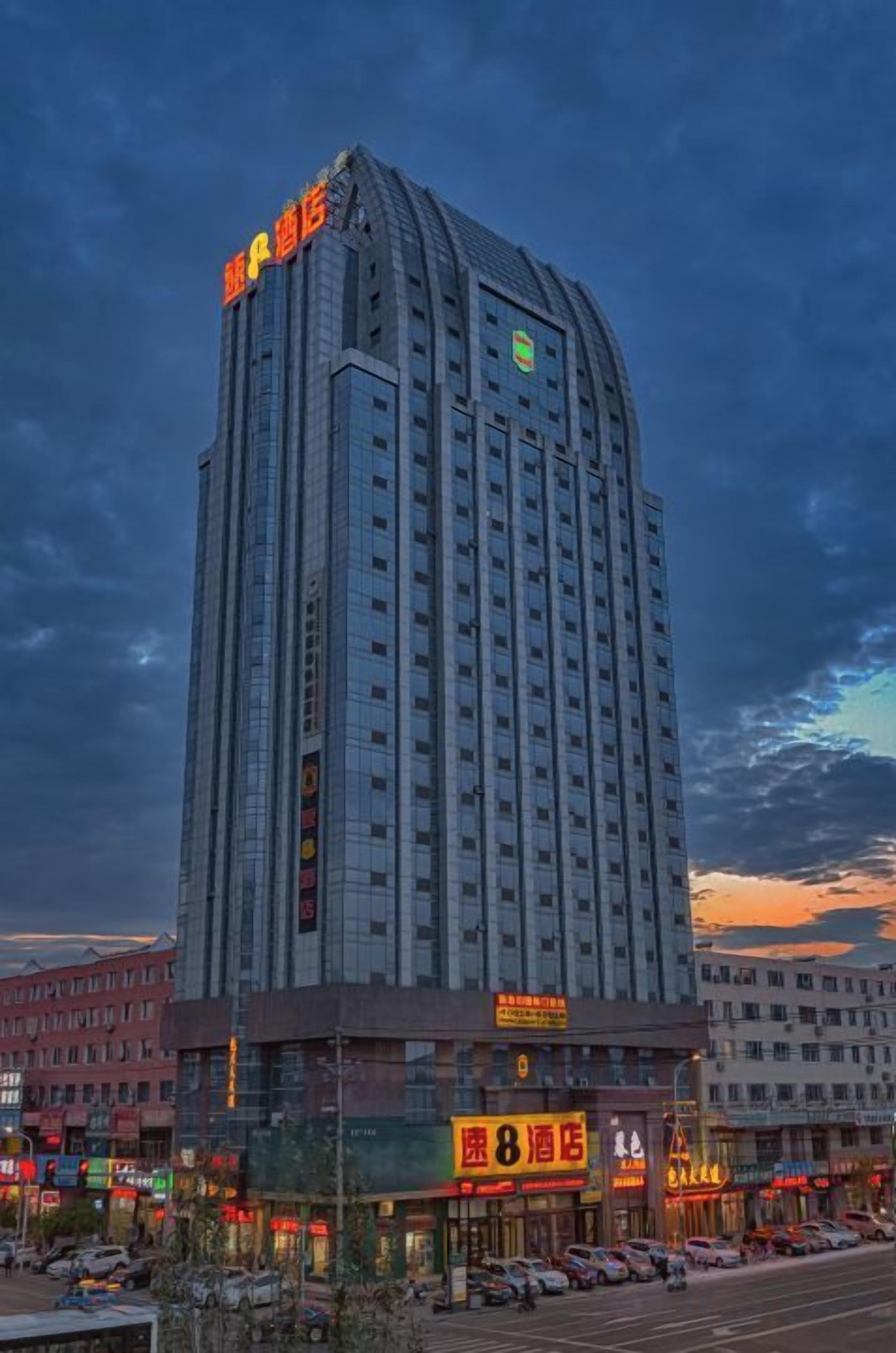 A tall hotel building with a prominent sign at the top.