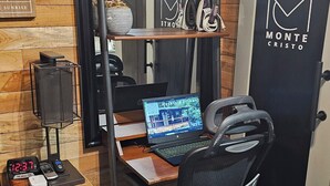 A compact office space with a desk, chair, and shelves.
