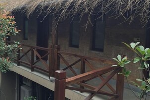 Un edificio tradicional con techo de paja y un balcón de madera.