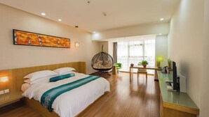 Habitación de hotel con cama, silla, escritorio, televisión y ventana.