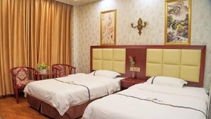A hotel room with two beds, a wooden desk, a chair, and a curtain. - Haihao Business Hotel (Chongqing)