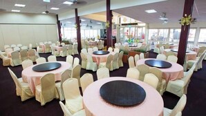 A banquet hall with round tables covered in pink tablecloths and white chairs. - Lakeside Resort (Nantou)