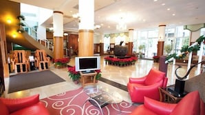 A spacious lobby with a large seating area, a television, and a staircase. - Lakeside Resort (Nantou)