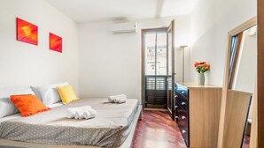 A bedroom with a bed, a dresser, a mirror, and two wall-mounted artworks. - GuestHost - Cozy apartment of 80 sqm, on two levels, for 2 people, located on the 1st floor of a building with lift (steps to access: not suitable for disabled people).The property is located in the heart of the historic center of Palermo (Restricted Tra (Palermo)