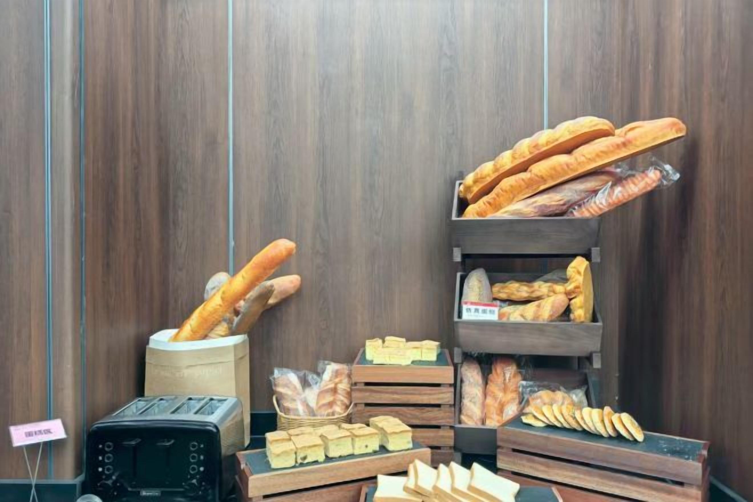 A bakery display with various breads and pastries.