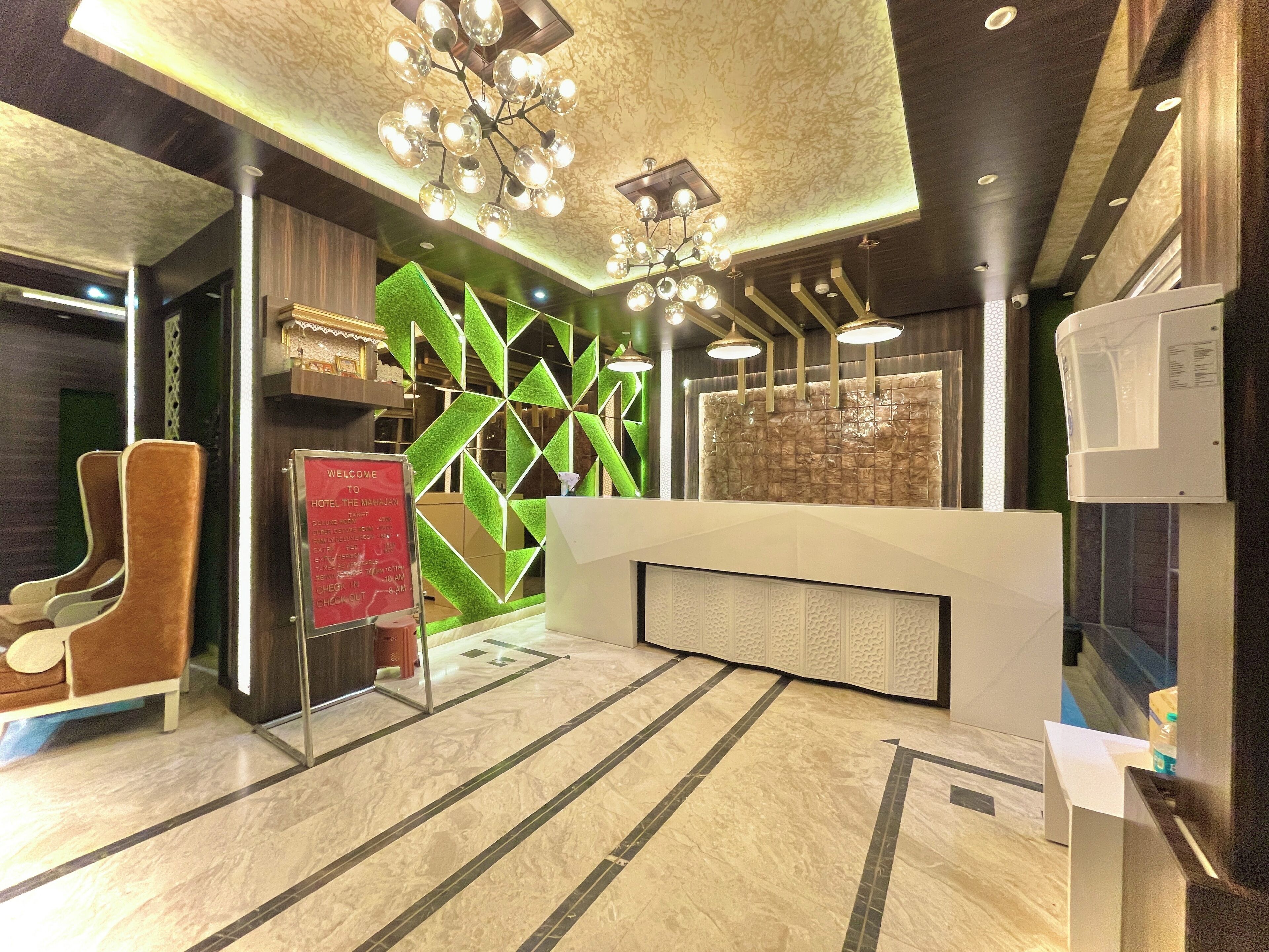 A hotel reception area with a modern design, including a reception desk, seating area, and decorative wall panels.