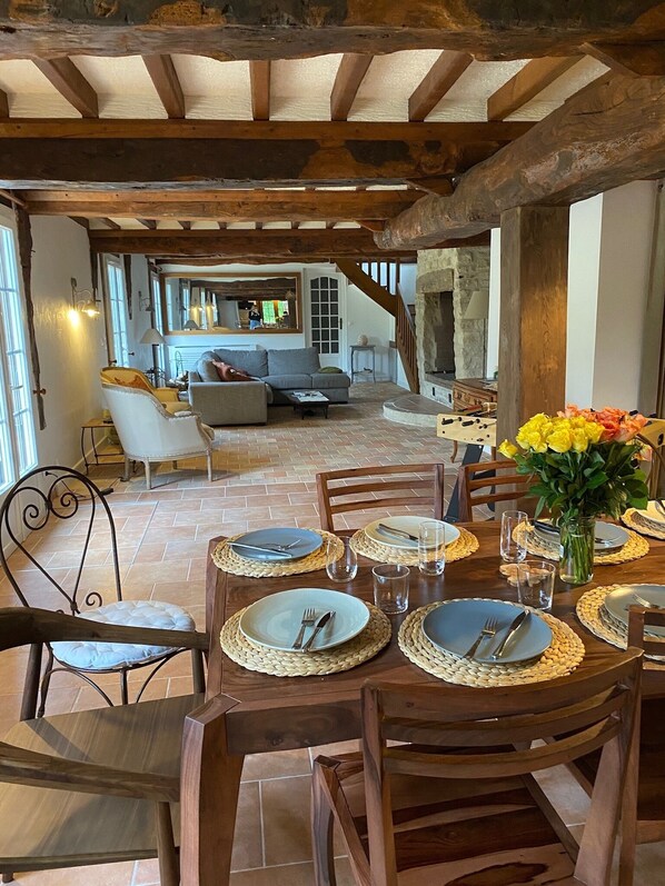 Enjoy meals in this charming dining area with a wooden table and exposed beams.