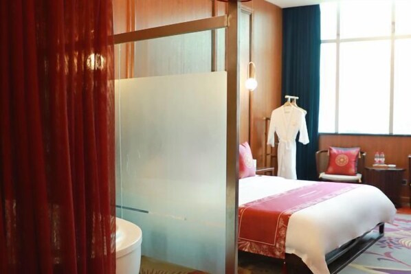 A hotel room with a bed, a wardrobe, a mirror, a window with curtains, and a nightstand with a lamp. - Chongqing Yuhao Hotel (Chongqing)