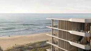 A modern multi-story building with balconies overlooking a beach and ocean. - Apartment in Palm Beach (Palm Beach)