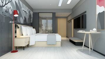 A modern bedroom with a bed, bedside table, lamp, and a large window.