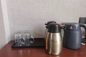 A coffee maker, a kettle, and three glasses on a tray. - Baibuting Hotel (Haiyan)
