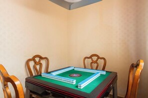 A room with a pool table, four wooden chairs, and a green felt surface. - Xiangshan Jiayi Sisters Holiday Villa (Xiangshan)
