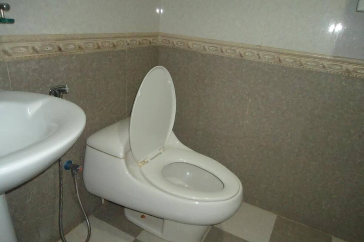 A bathroom with a toilet and a sink.